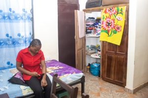 student sitting on bed